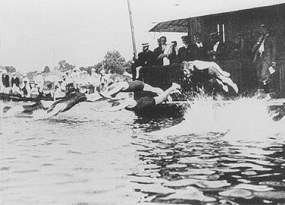Swimmers competing at the 1900 Olympics dive into the river Seine