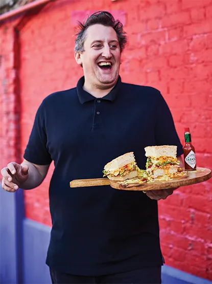 Max Halley holding one of his gourmet sandwiches