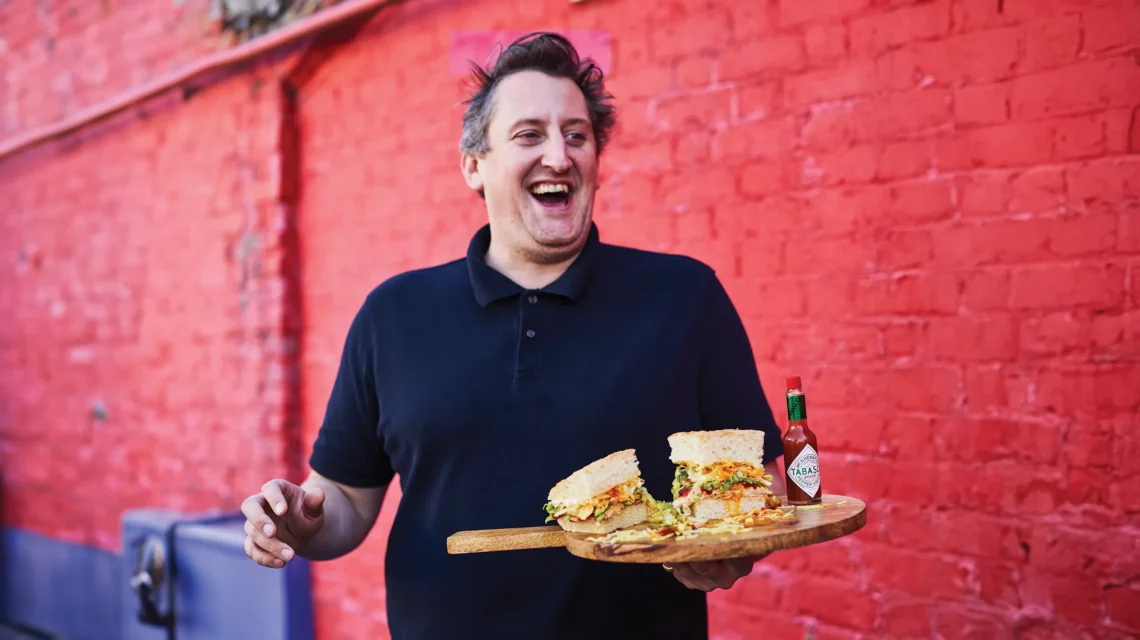 Max Halley holding one of his gourmet sandwiches