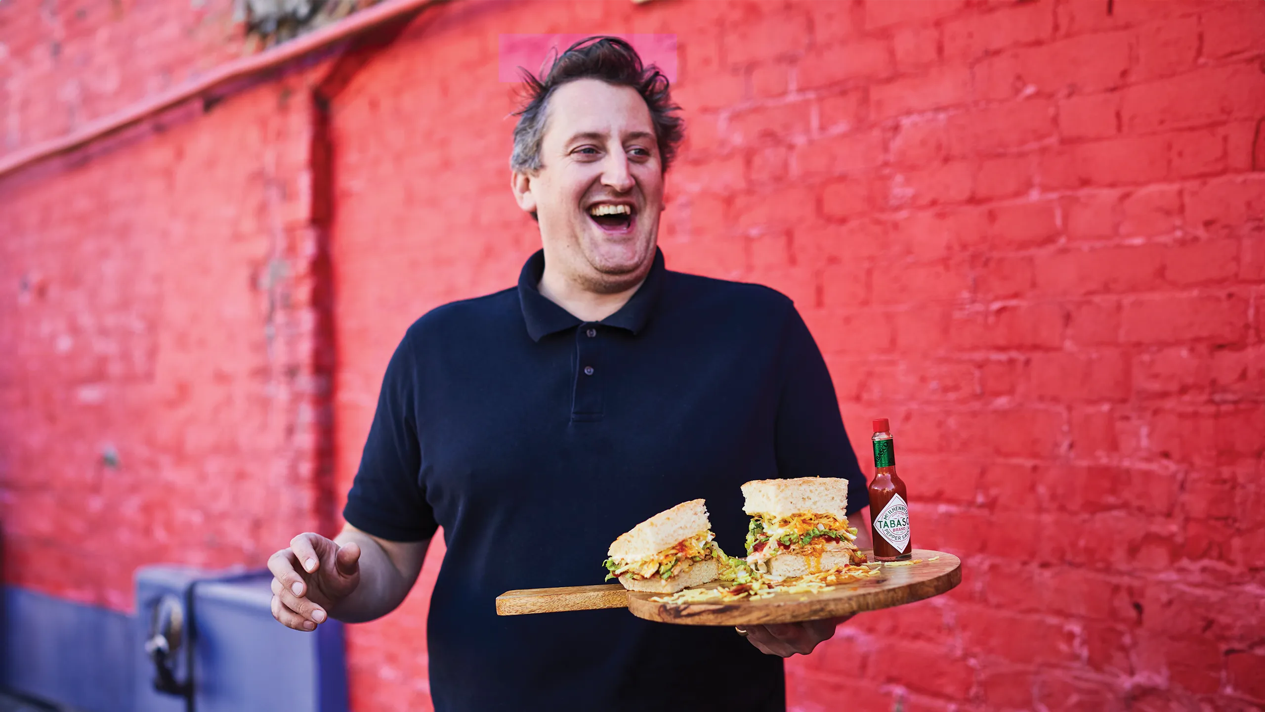 Max Halley holding one of his gourmet sandwiches