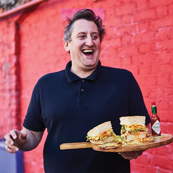 Max Halley holding one of his gourmet sandwiches