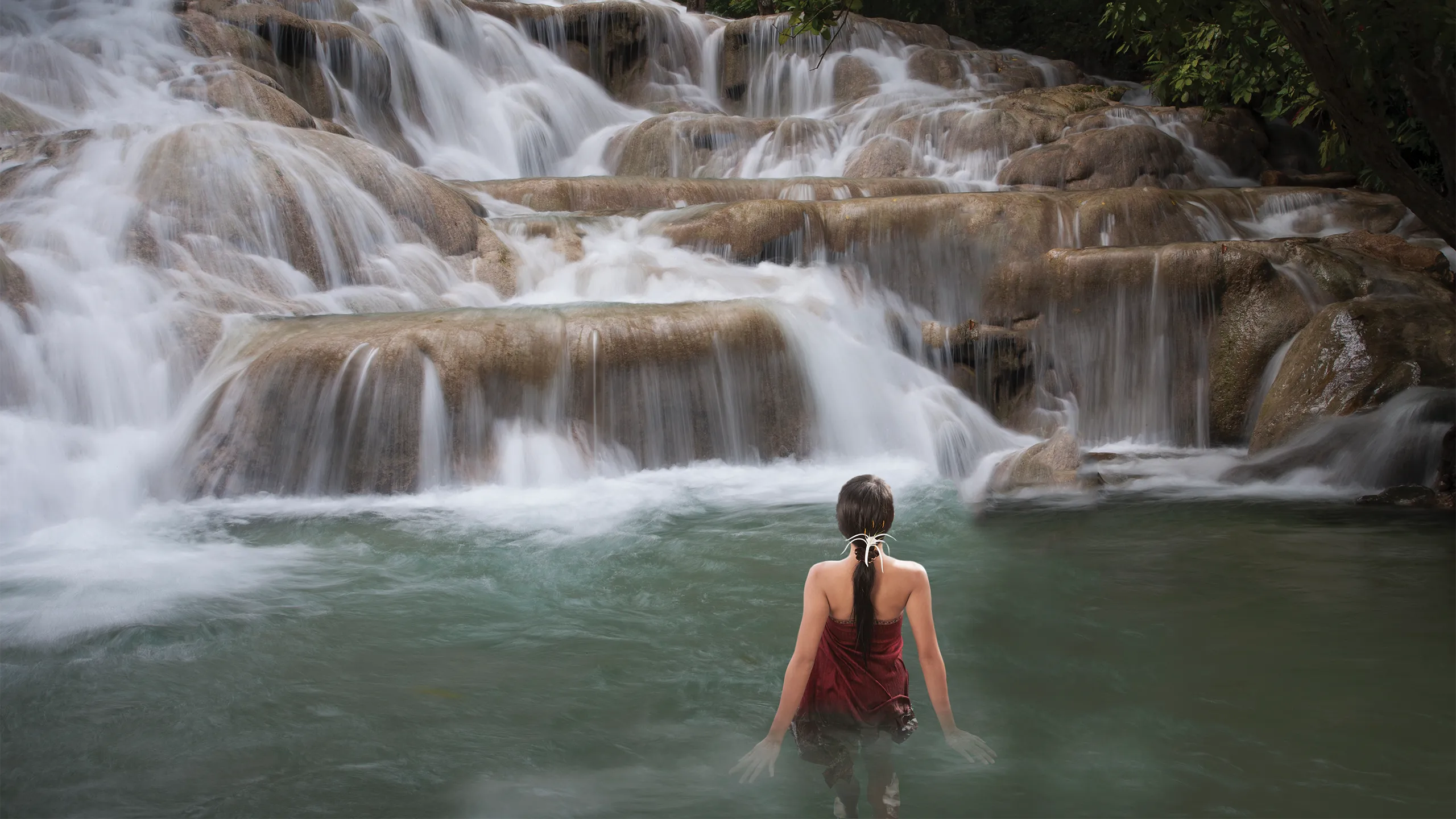 Woman standing in Dunn's River waterfalls