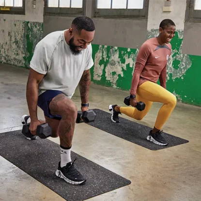 Image of a man and a women in a gym doing a lunge