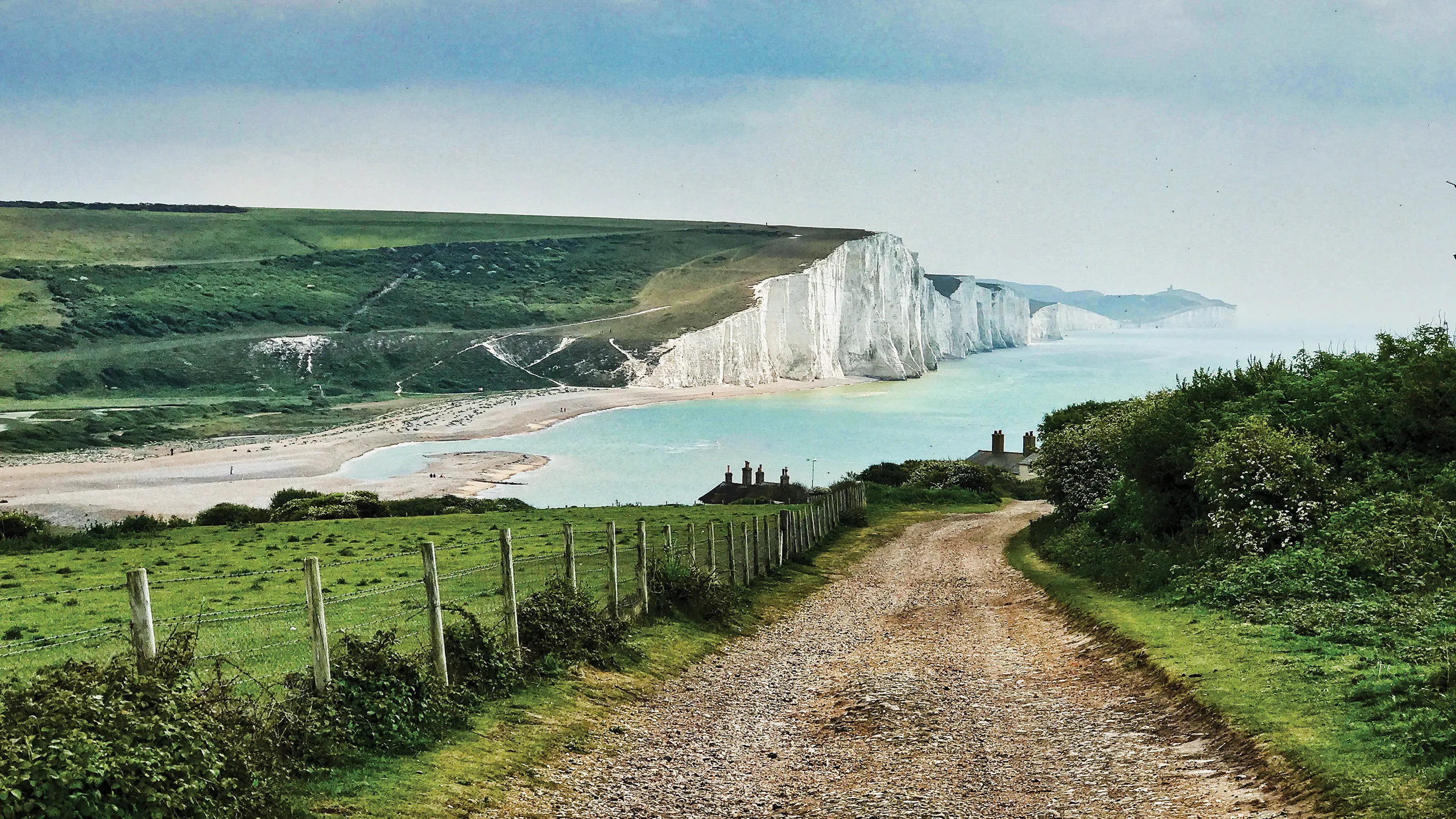 View of white cliffs with a path leading to the sea