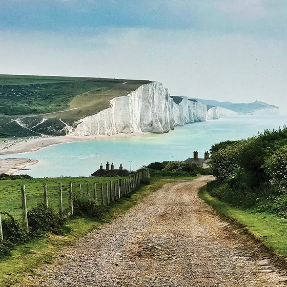 View of white cliffs with a path leading to the sea