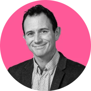 Profile image of Tom Hall on a pink circle background