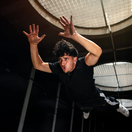 Calisthenics champion Demetri Alvanis jumping and diving in an urban space